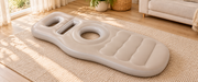 The full beige maternity cushion in a bright living room