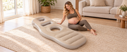 Pregnant model beside the beige maternity cushion in a bright living room